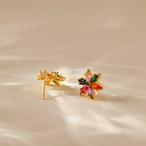 Detailed view of gold floral stud earrings featuring vibrant colorful zircon stone petals