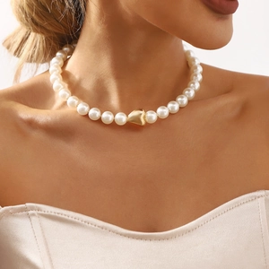 Elegant vintage white pearl necklace for women featuring a polished gold heart pendant