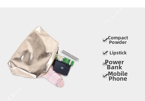 Interior capacity of gold tote bag showing space for phone, lipstick and essentials