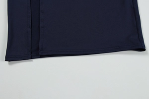 Detail shot of a sleek side slit and durable stitching on a slim blue evening dress
