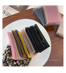 Close-up of colorful nylon hair fringe stickers showing mesh texture and various shades