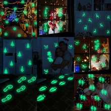 Detail of glow-in-the-dark Christmas stickers showing luminous snowflakes and reindeer