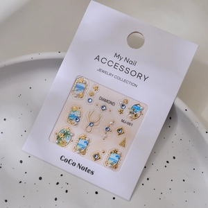 Detailed macro view of 3D ocean-themed nail charms with gold shells and pearls
