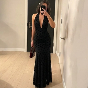Detail of black polka dot halter maxi dress with deep V-neck and ruffled waist