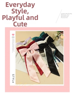 Macro shot of colorful satin bow hair clips with long ribbons in multiple shades