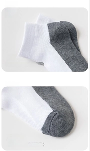 Close-up of 3D knit heel and flat toe seam on breathable mesh white cotton socks