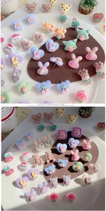 Detailed view of colorful flocked heart and cartoon animal stud earrings with soft texture