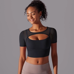 Detail of black mesh patchwork crop top with cutout design for yoga and fitness training