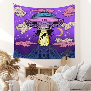 Detail of bohemian tapestry featuring a psychedelic UFO design over snowy mountains