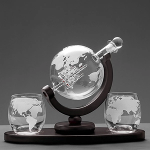 Detailed set of globe decanter with glass sailing ship inside and two etched world map glasses