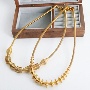Modern gold-plated titanium steel necklaces with unique spiral coil designs on white background