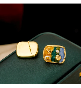 Detailed macro view of starfish earrings showing front enamel work and golden metal back