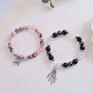 Punk style beaded bracelets with skull and bone charms made of natural stones and crystals