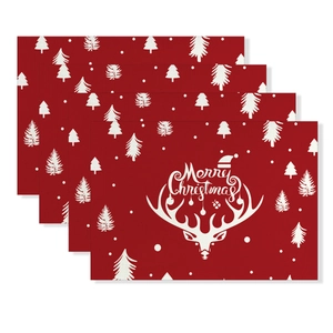 Close-up of red Merry Christmas placemats with reindeer motifs in a 4-piece dining set