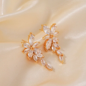 Elegant gold flower drop earrings with clear marquise zircon petals on silk background