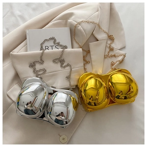 Detailed close-up of metallic gold and silver breast-shaped acrylic evening clutch bags