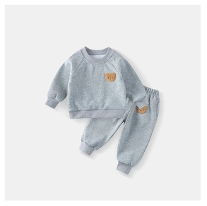 Detail view of grey kids sweatshirt set with plush bear patches and ribbed cuffs