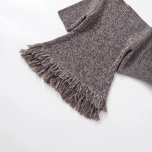 Dark gray chunky knit top featuring fashionable tassel fringe trim on a white background