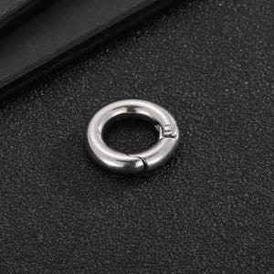 Polished silver stainless steel round spring clasp for jewelry making on black background
