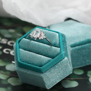 Detail of s925 silver zircon ring with rectangle stone in a green velvet box