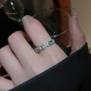 Detailed close-up of adjustable silver ring with blue oval zircon and sparkling pavé stones