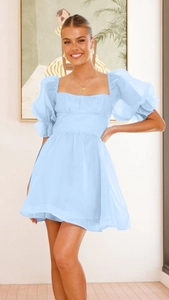 Detail der hellblauen Organza-Puffärmel und des quadratischen Ausschnitts am Minikleid