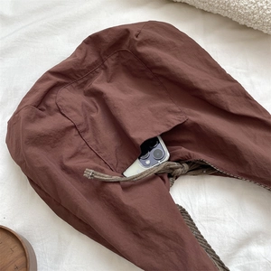 Brown corduroy shoulder bag with woven rope strap and pocket detail for smartphones