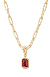 Detailed close-up of 18K gold-plated paperclip chain with emerald-cut red stone pendant