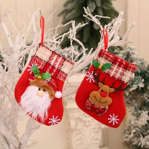 Red Christmas stocking set with Santa and Reindeer figures hanging on white branches