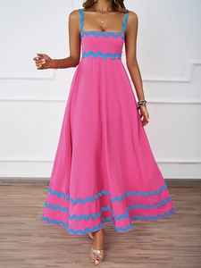 Detail of rose pink maxi dress with contrasting blue wavy trim on the straps and hem