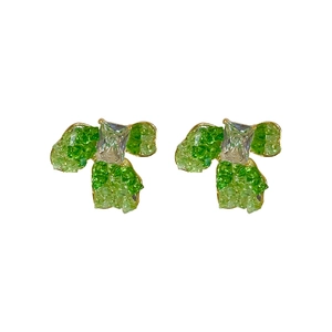Bow-shaped gold plated earrings with green faceted gems and rectangular clear stone centerpiece