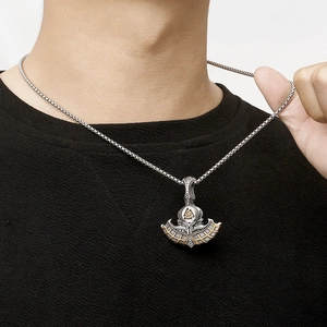 Close-up of a silver and gold Viking axe pendant with Valknut symbol on a neck chain