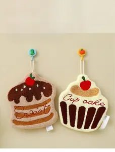 Detail of creative cupcake and cake shaped hanging hand towels in thick coral fleece