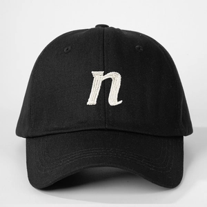 Classic black cotton baseball cap with white embroidered letter n and adjustable strap