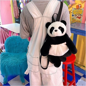 Close-up of plush panda backpack with soft faux fur texture and slim black straps