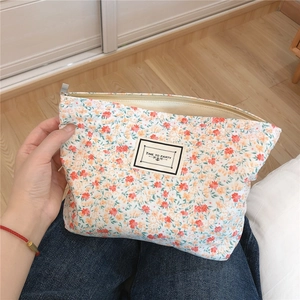 Macro detail of floral cotton makeup bag with zipper and Time to Party fabric label