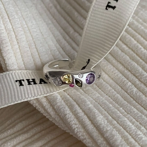 Close-up of adjustable silver ring with colorful heart zircons and star engraving