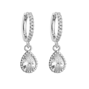Macro detail of silver drop earrings featuring pavé set hoops and pear-cut zircon pendants