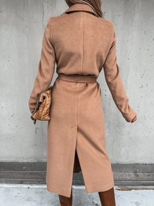 Detail of caramel wool coat back featuring waist-cinching belt and rear hem split