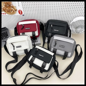 Detailed view of trendy canvas crossbody bags in five colors with double buckle closure