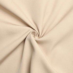 Close-up of the beige knit fabric texture showing high-quality softness and drape