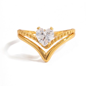 Detail view of gold stainless steel ring with heart-cut zircon and V-shaped band