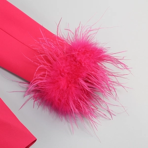 Close-up of vibrant rose pink blazer sleeves featuring premium ostrich feather trim details