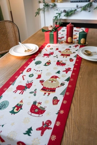 Close-up of festive Christmas table runner with reindeer and Santa Claus jacquard patterns