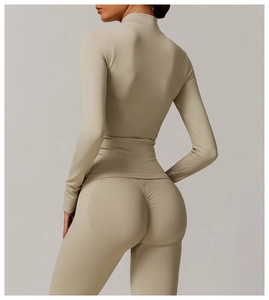 Macro view of the seamless rib-knit collar and zipper detail on the khaki yoga jacket