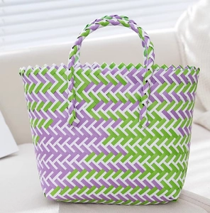 Close-up of the purple and green hand-woven pattern and sturdy double handles