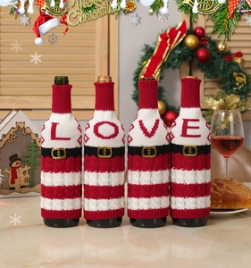 Detail of knitted Christmas wine bottle covers featuring LOVE letters and striped patterns