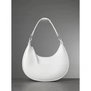 Detailed macro view of white half-moon hobo bag featuring silver metal rings and smooth leather