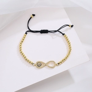 Adjustable infinity and evil eye braided bracelet with gold beads and zircon accents