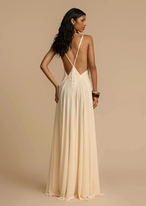 Detail of cross straps and intricate lace patchwork on the back of a cream maxi dress
